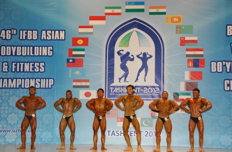 Bodybuilders posing on stage at a championship event