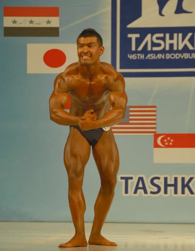 Athlete poses on stage during a sports competition