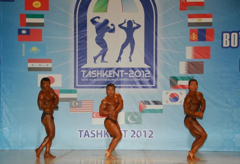 Bodybuilders posing on stage during a competition