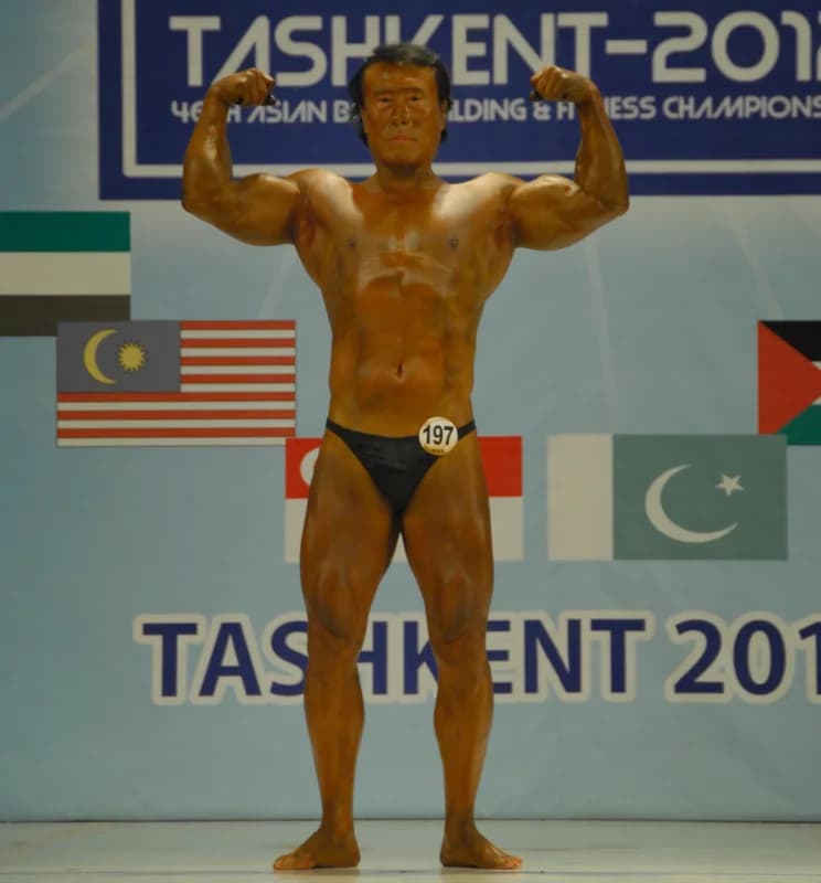 Athlete poses on stage during competition
