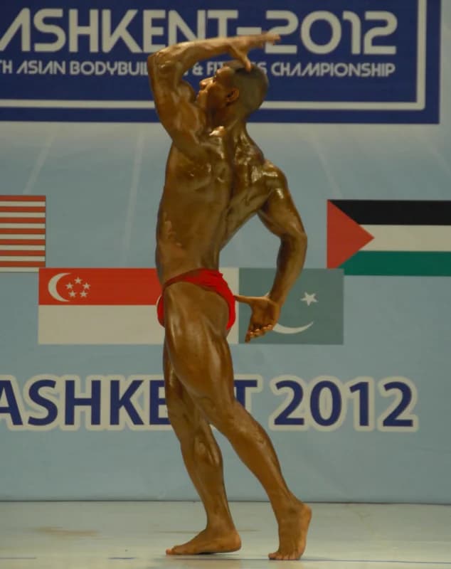 Athlete posing on stage during a bodybuilding competition