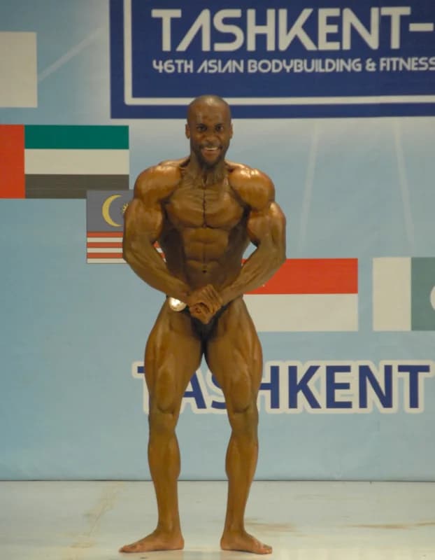 Athlete posing on stage during a bodybuilding competition