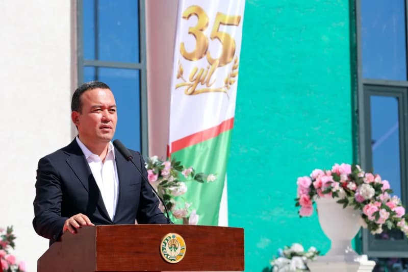 Man speaking at a podium outdoors