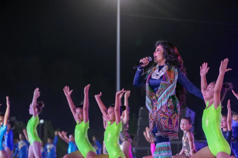 Performer singing into a microphone on stage