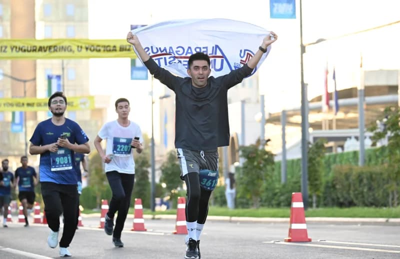 Participant holding a banner while running in a street race