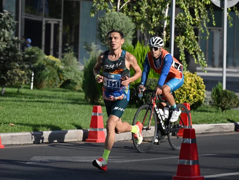 Athlete running along a city street during a competition