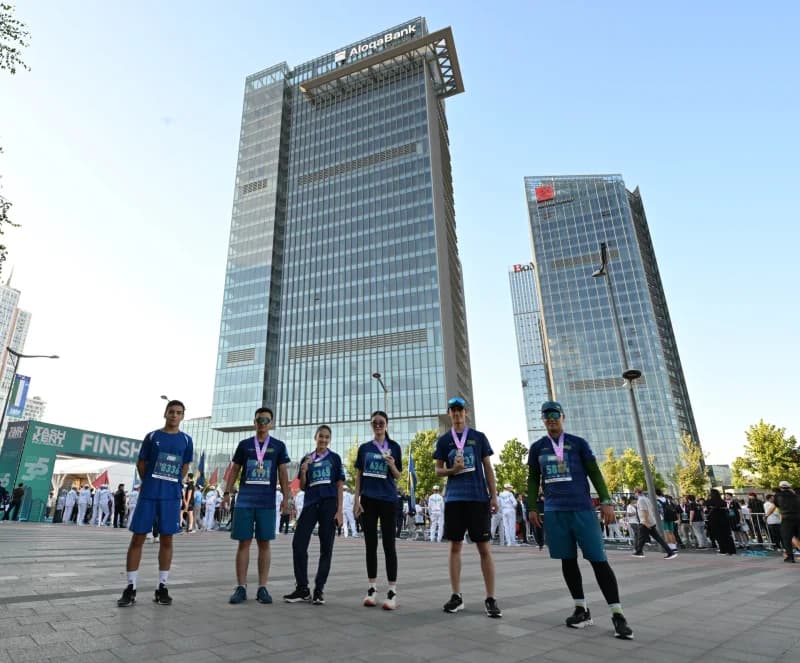 Participants posing in front of modern high-rise buildings