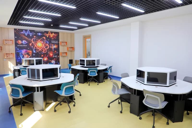 Modern computer classroom interior with hexagonal workstation desks
