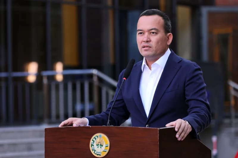 Man speaking at a podium outdoors
