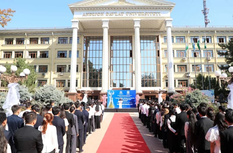 People gathered outside a large building with columns