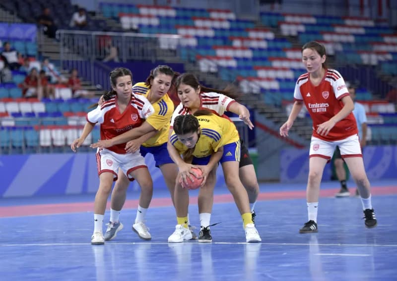 Female athletes competing in an indoor match