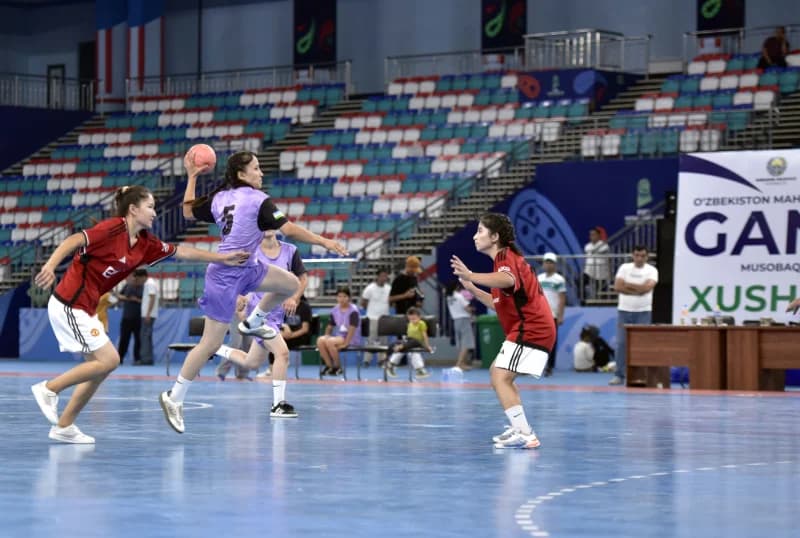 Athletes competing in an indoor ball game match