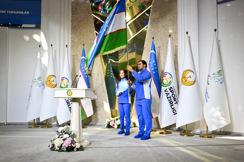 People holding a flag indoors