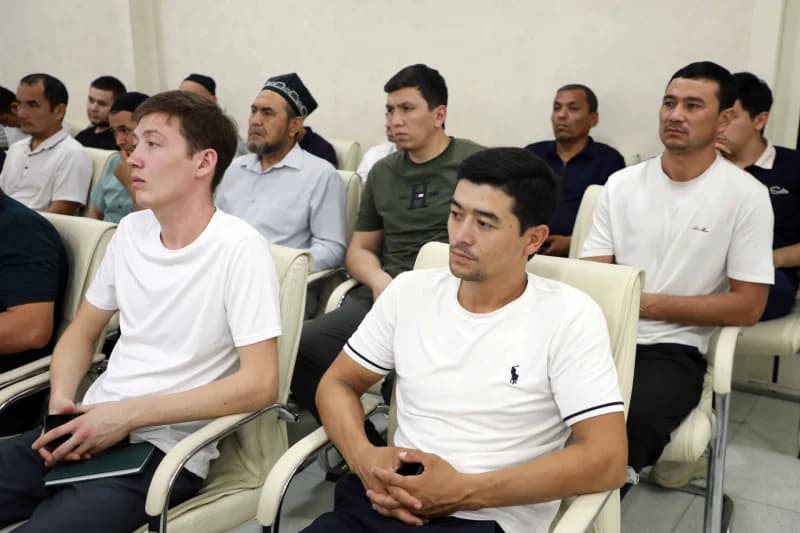 Group of men seated in an interior setting