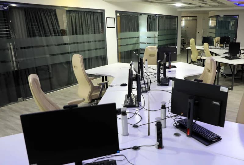 Modern office interior with empty desks and computer workstations