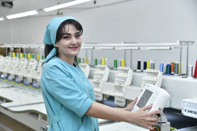 Woman working at industrial machinery