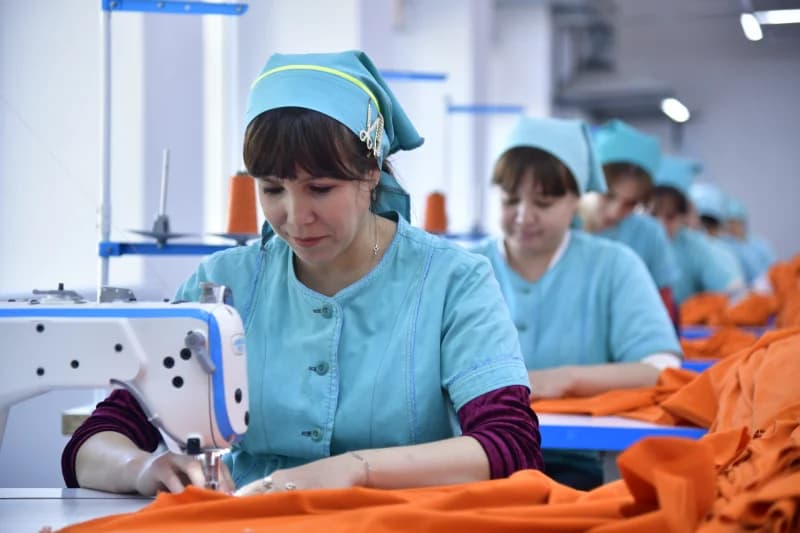 Women working at sewing machines in a textile factory