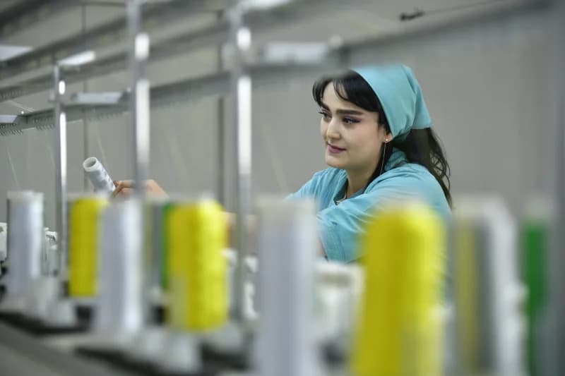 Person working with textile machinery