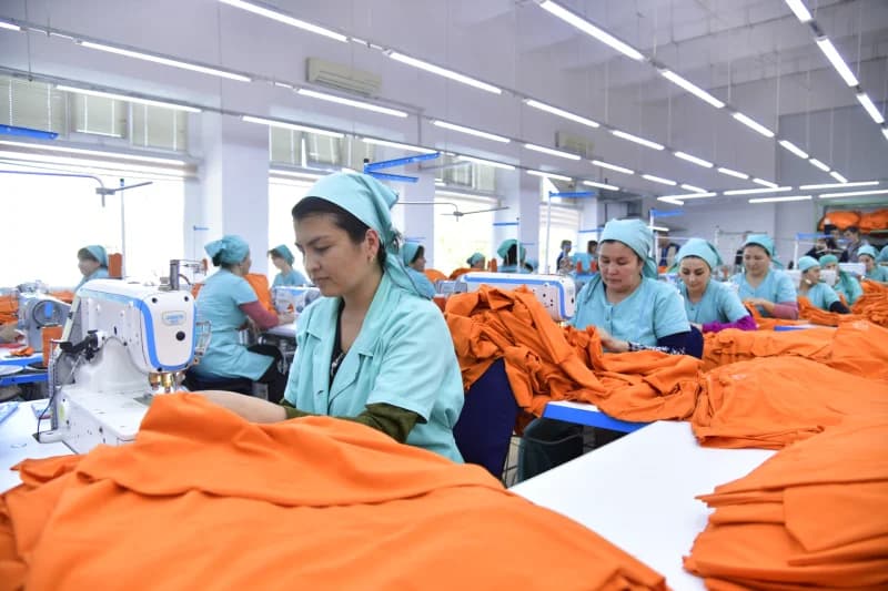Workers sewing garments in a factory workshop