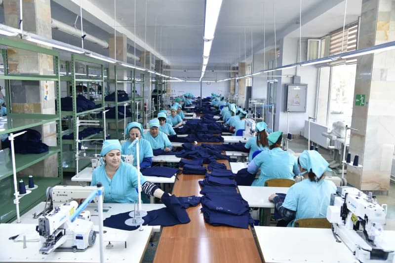 Workers sewing garments in a textile factory
