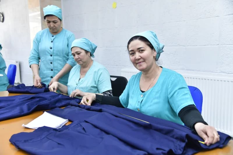 Women working at a textile production table