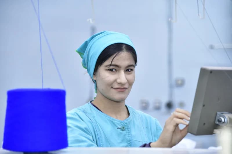 Worker operating machinery in a manufacturing setting