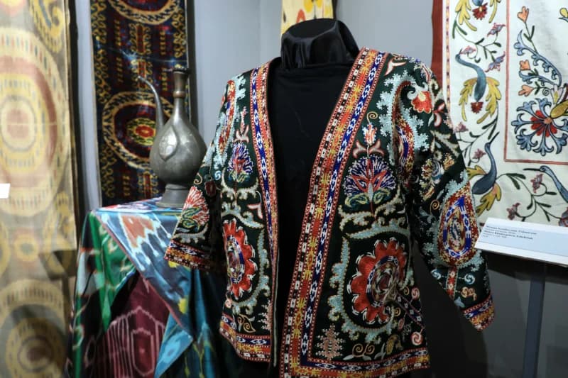 Traditional embroidered garment displayed on a mannequin