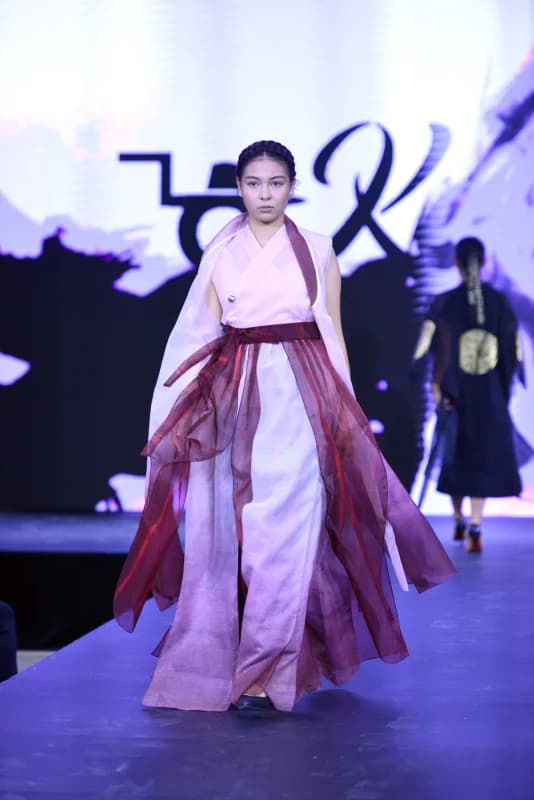 Model walks on runway in fashion show