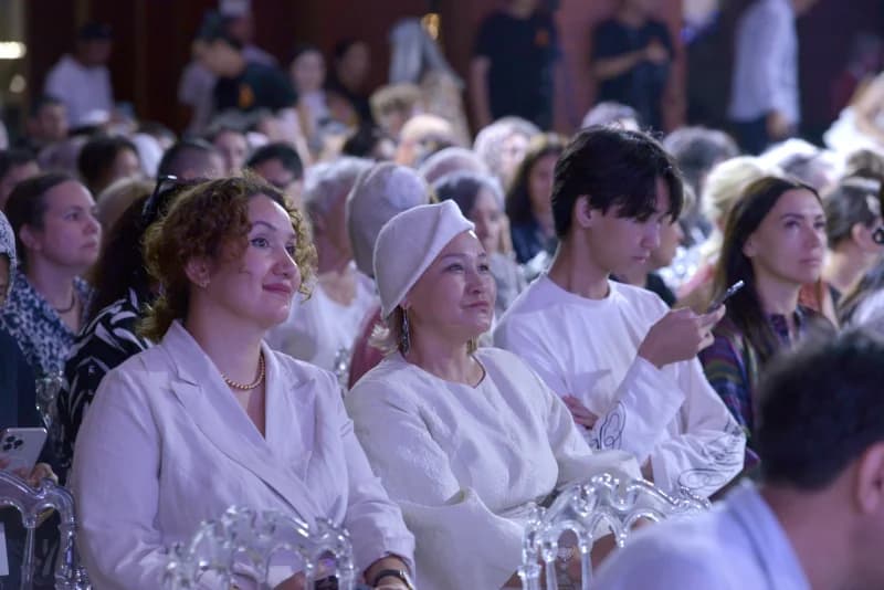 People seated in an audience indoors