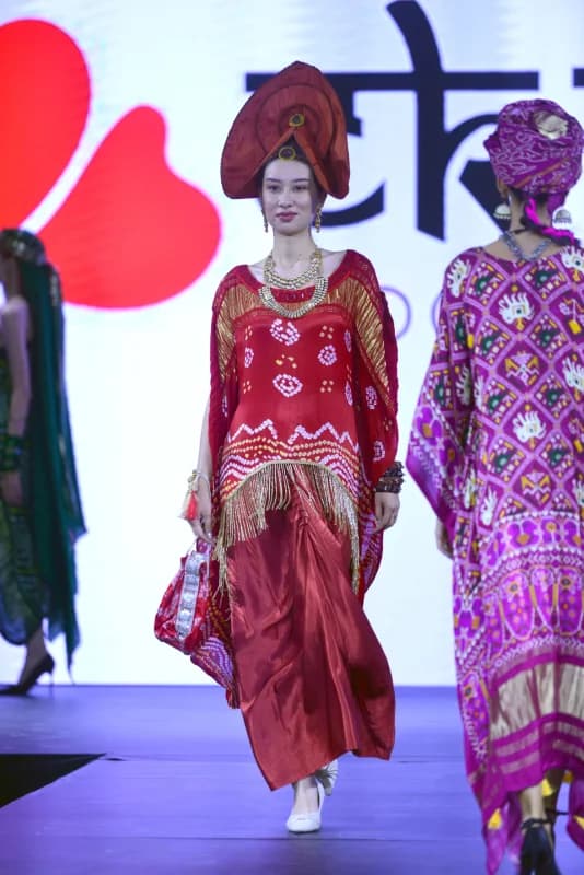 Models presenting traditional attire on stage