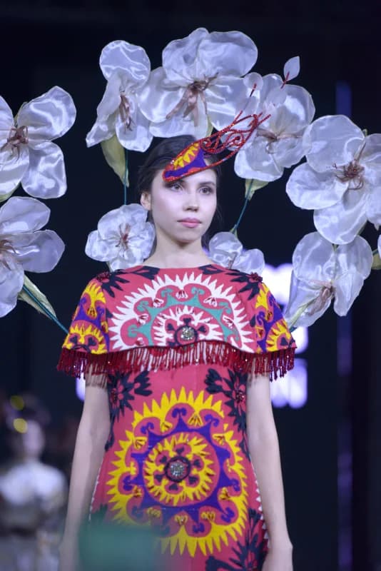 Person wearing a patterned garment and a decorative floral headpiece