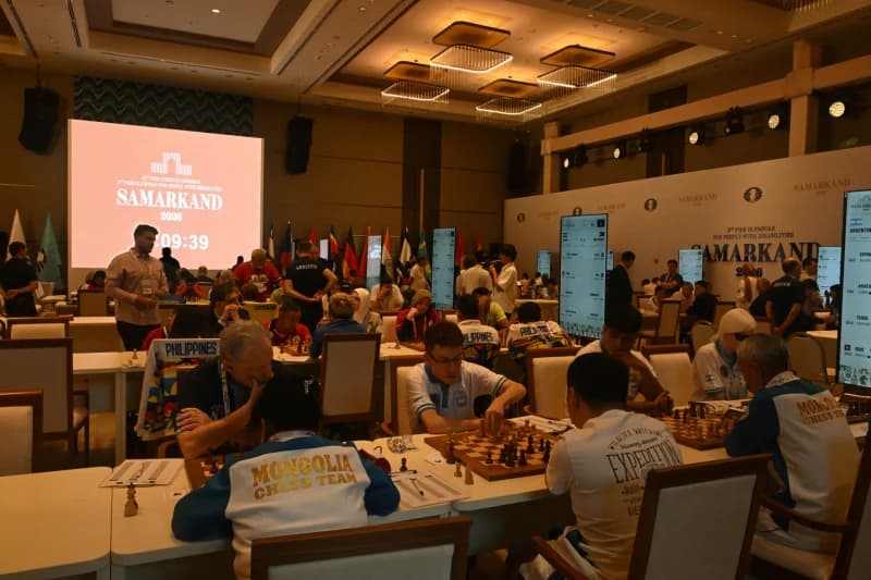 People playing chess during tournament in hall