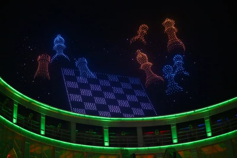 Light display forming chess pieces in the night sky