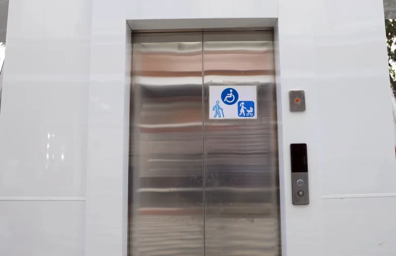 Modern elevator doors with accessibility signs