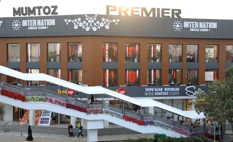 Modern commercial building exterior with pedestrian overpass