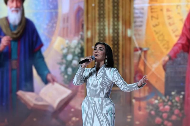 Woman performing on stage with microphone