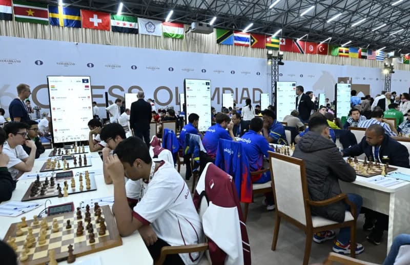 Competitors playing chess at a large tournament hall