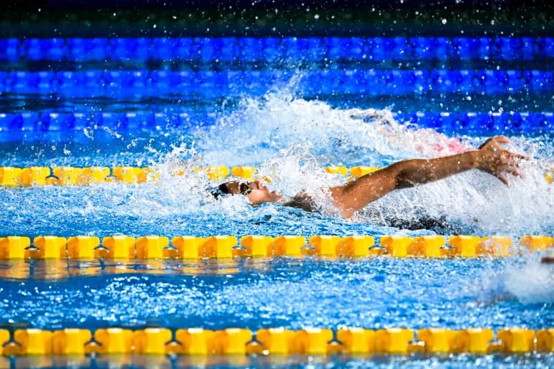 Swimmer competing in pool