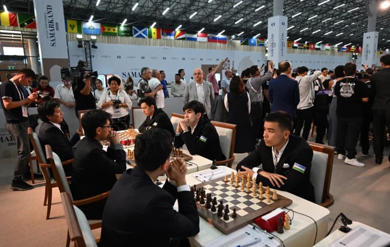 Competitors playing chess at a tournament hall
