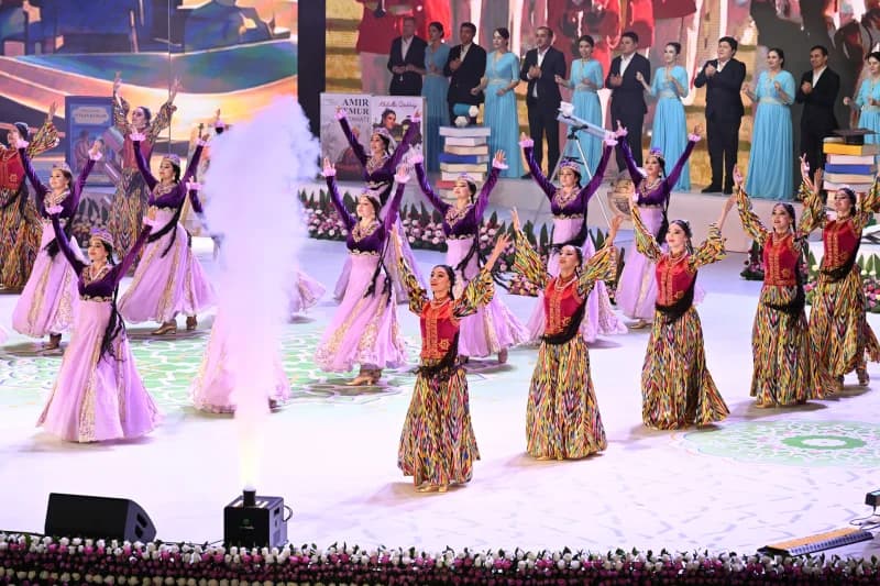 Performers in traditional clothing on stage during cultural event