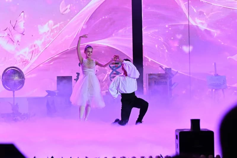 Performers dancing on stage in a theatrical production