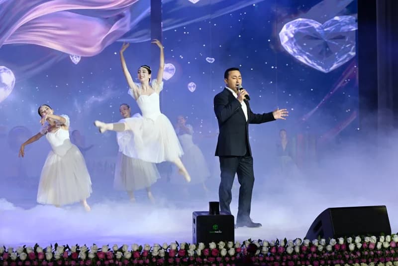 Performer singing on stage with dancers