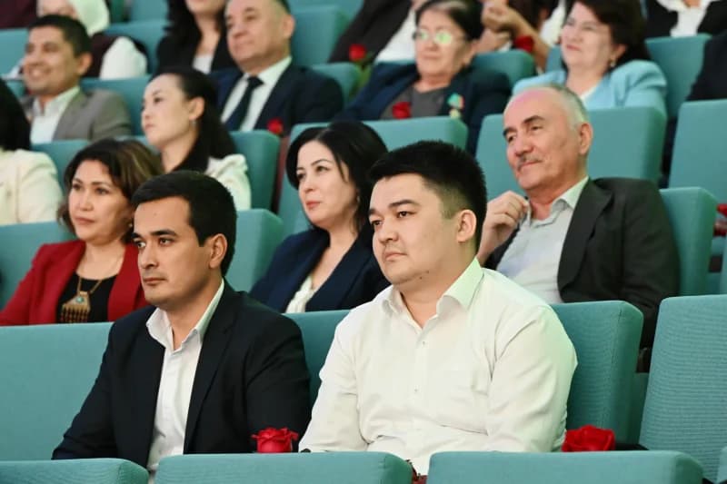 People seated in an audience listening attentively