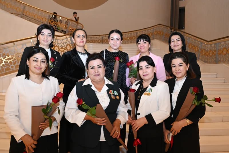 Group of women holding flowers on stairs