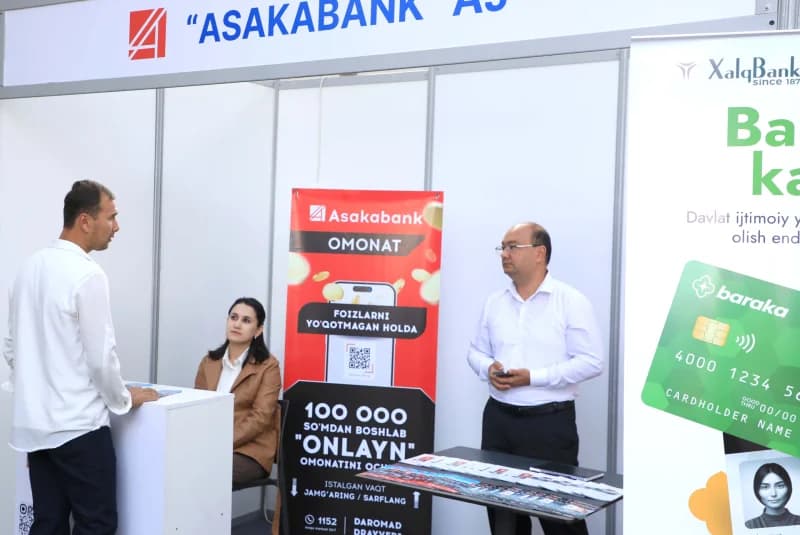 People at exhibition stands with bank signage