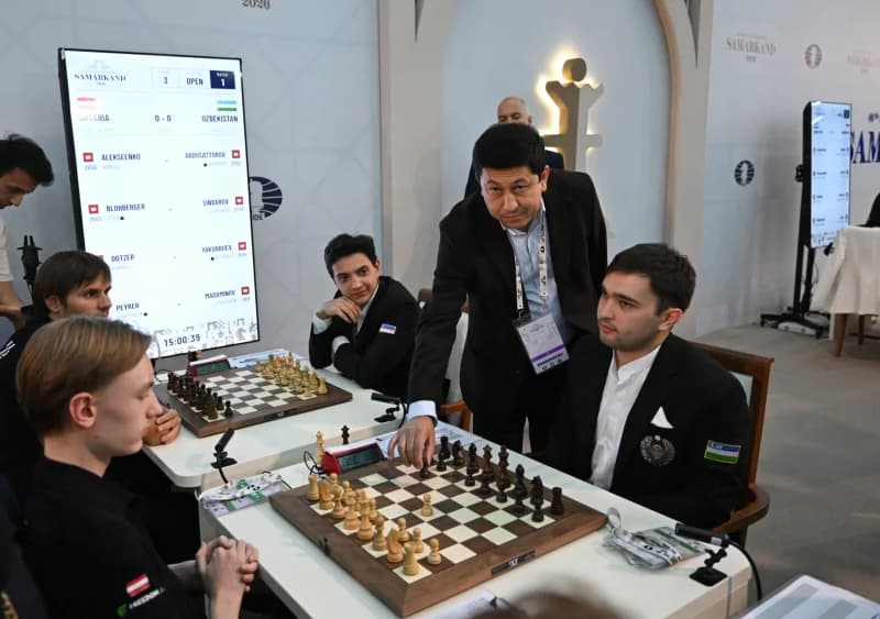 Players and referee at a chess competition table