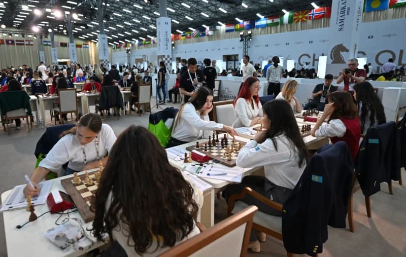 People playing chess in a tournament hall