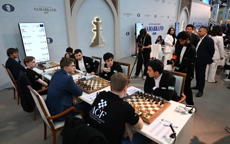 Players compete at chess boards during a tournament
