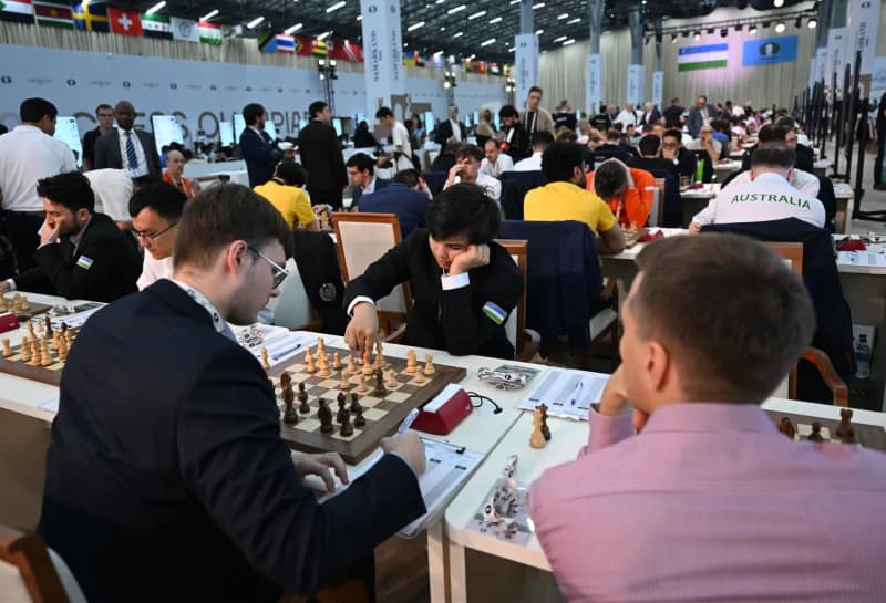 People participating in a chess competition in a large hall