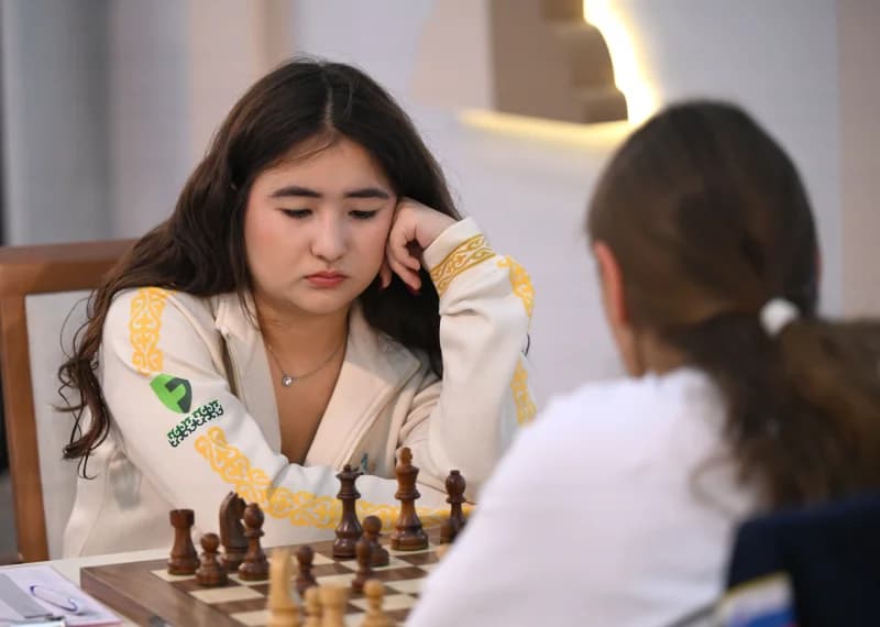 People playing a chess game in an indoor setting